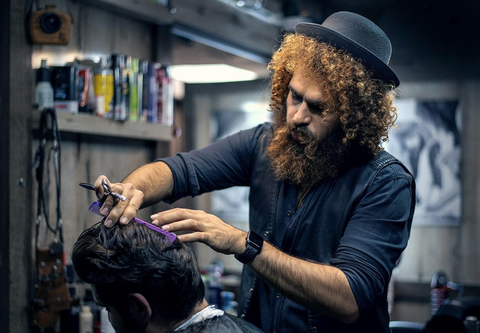 A barber mid-cut with a client in the chair